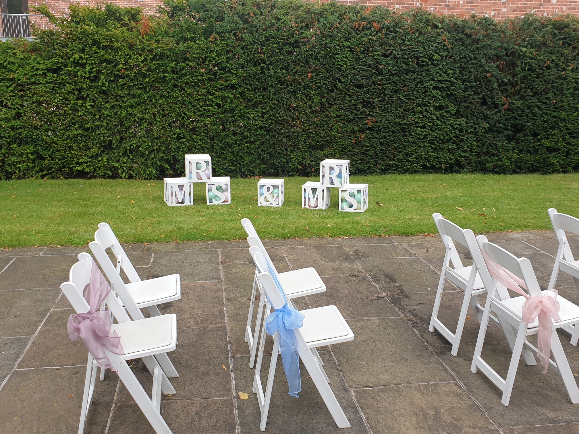 We are selling our laser cut wooden Mrs & Mrs boxes (of course you could use as Mr & Mrs, mr & Mr). Each box is 30 x 30 x30 cm in size, light weight and can easily be painted to any colour you wish. The tops can be removed to fill with coloured sashes or balloons of your choice. These make a lovely feature on stage, to fill a corner stacked or laid out in an outdoor display like shown in the photos.
This is our display set and ready painted in white. We sell these flat pack normally at £40 per letter. We are selling this set of 7 boxes for £110. Collection only from Swinton S64 8AE.